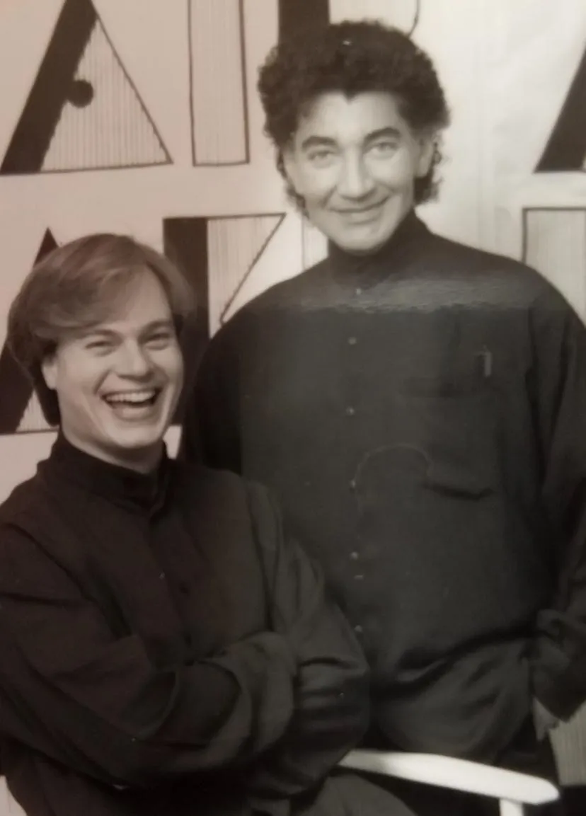Archival black-and-white photograph of L.A. Monroe Hair Studio's founders sharing a laugh