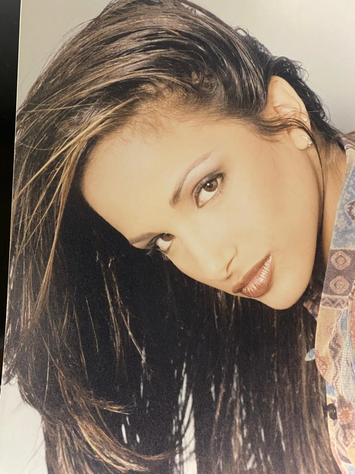 Long brunette hair with honey highlights and a glossy editorial finish